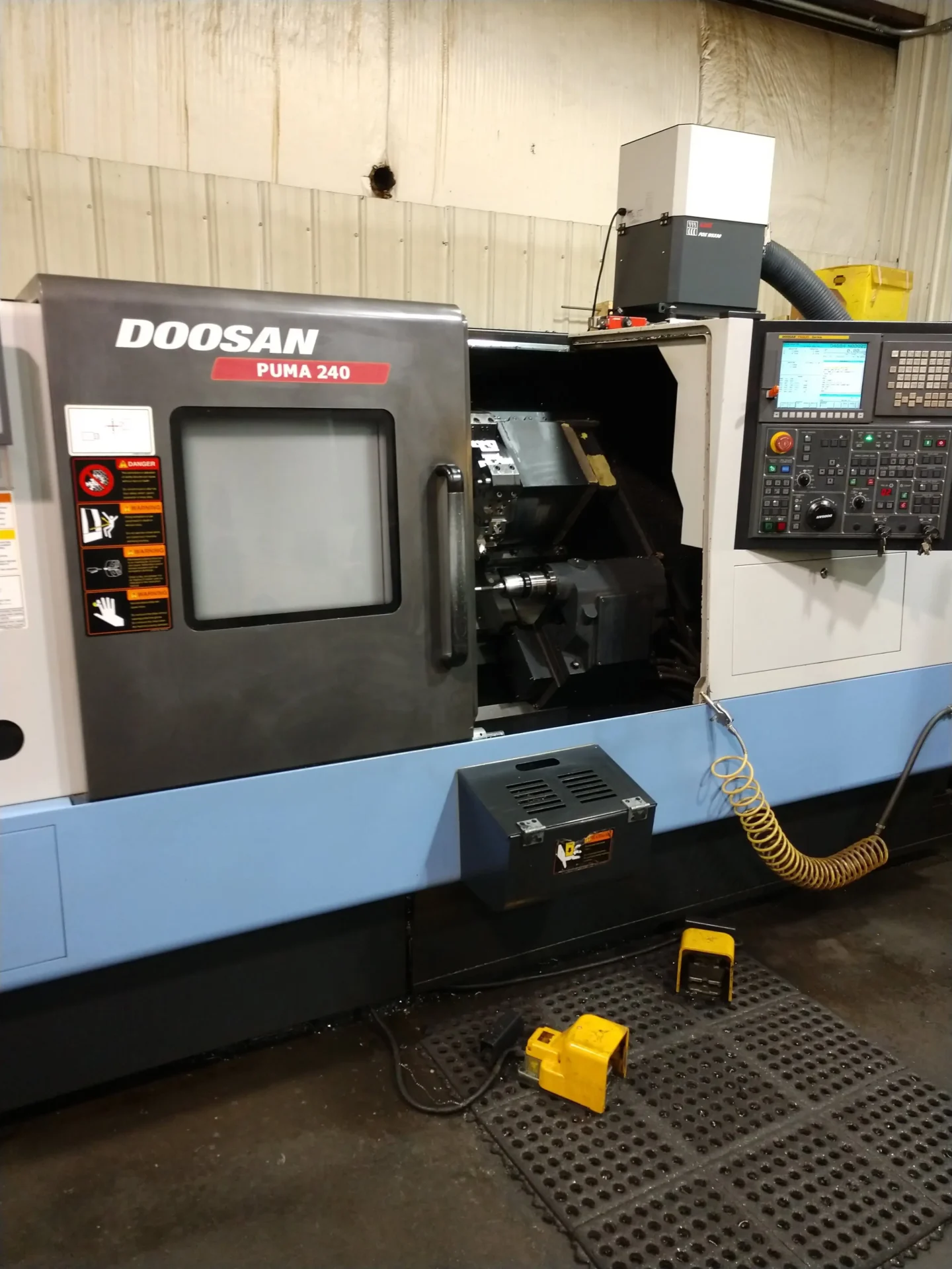 A Doosan Puma 1200 CNC machine in an industrial workshop.